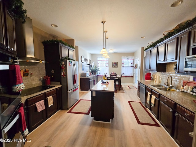 kitchen featuring pendant lighting, tasteful backsplash, appliances with stainless steel finishes, and a kitchen island