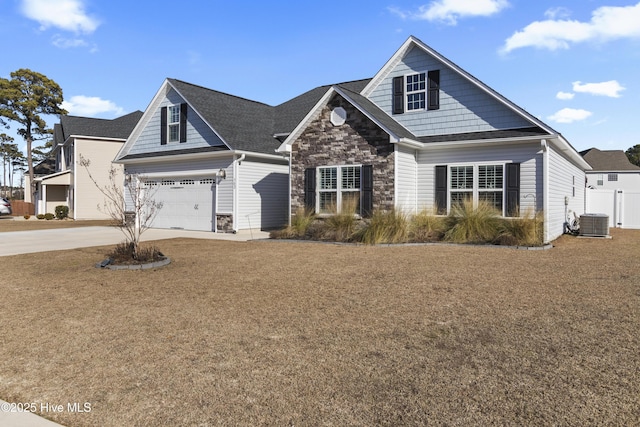 view of front of home featuring central AC and a garage