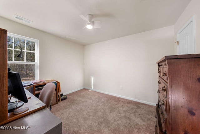 office area featuring baseboards, a ceiling fan, visible vents, and carpet floors