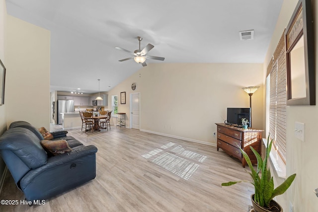 living area with light wood-type flooring, baseboards, visible vents, lofted ceiling, and ceiling fan