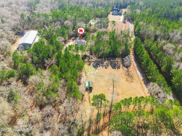 birds eye view of property with a wooded view