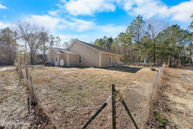 view of side of property featuring fence