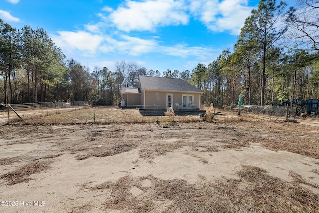 back of property featuring fence and french doors