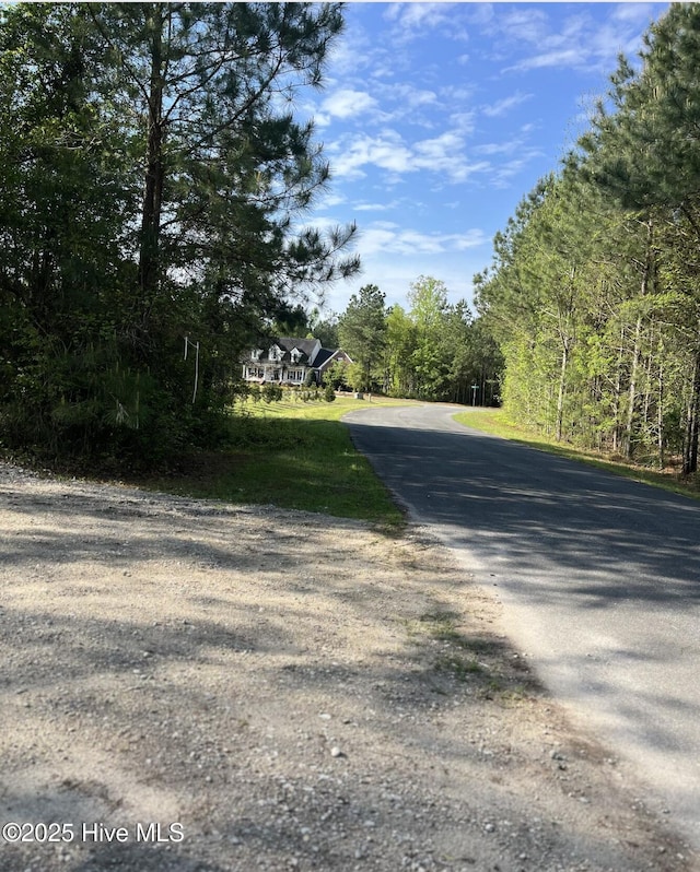view of street featuring a wooded view
