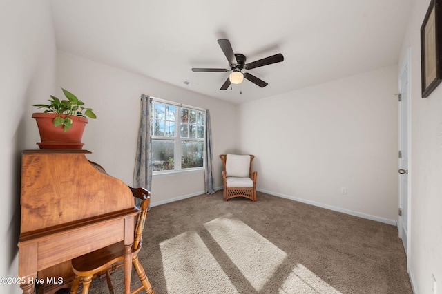 living area with ceiling fan and dark colored carpet