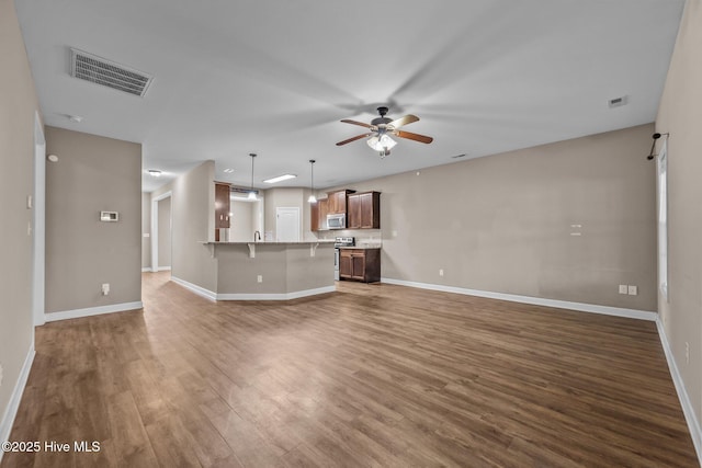 402 Kinroff Dr, Hubert, NC 28539 - unfurnished living room with a ceiling fan, dark wood-style floors, and baseboards