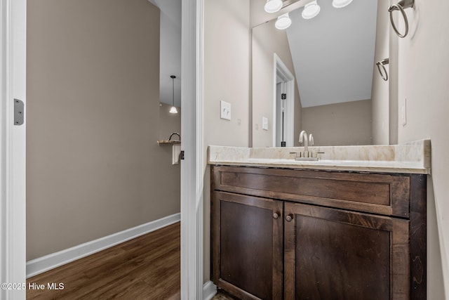 402 Kinroff Dr, Hubert, NC 28539 - bathroom with vanity, wood finished floors, baseboards, and vaulted ceiling