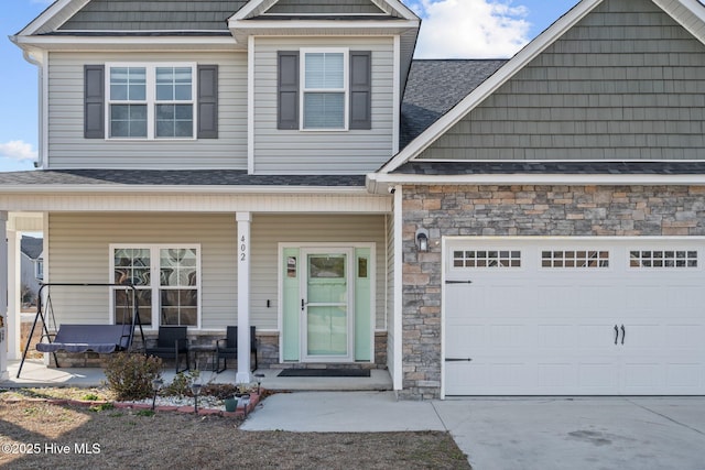 view of front of home featuring a garage and covered porch