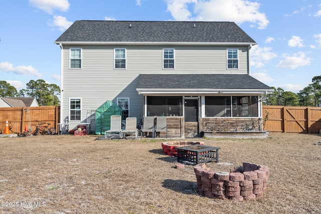 402 Kinroff Dr, Hubert, NC 28539 - back of house featuring an outdoor fire pit, a sunroom, a fenced backyard, and a shingled roof