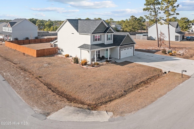 402 Kinroff Dr, Hubert, NC 28539 - traditional home featuring driveway, covered porch, an attached garage, and roof with shingles