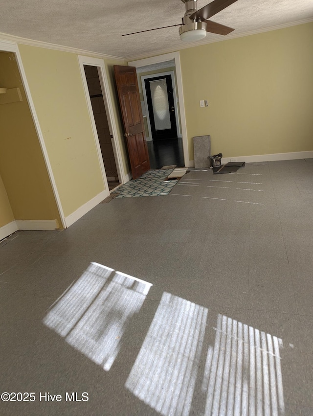 spare room with a textured ceiling and ceiling fan