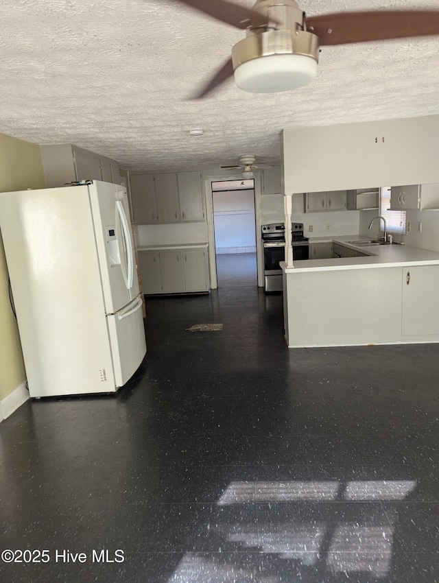 kitchen featuring white fridge with ice dispenser, paneled fridge, a textured ceiling, stainless steel range with electric cooktop, and sink