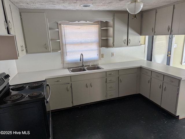 kitchen featuring sink, kitchen peninsula, a textured ceiling, and electric range oven