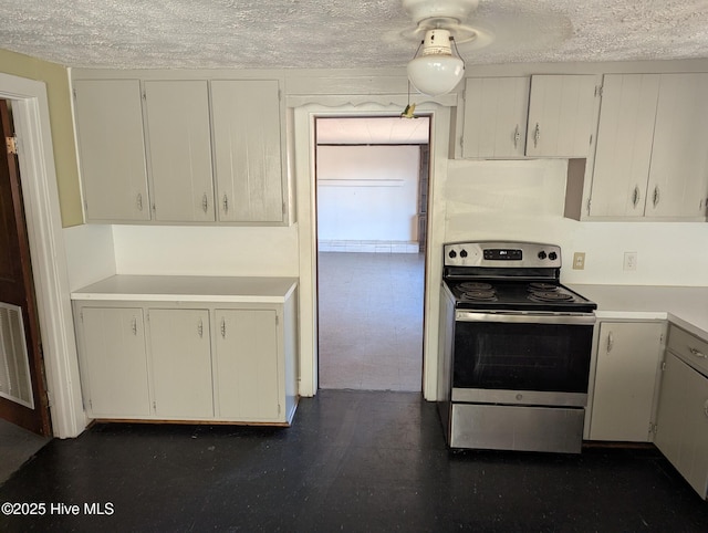 kitchen featuring a textured ceiling, stainless steel electric range oven, and white cabinetry