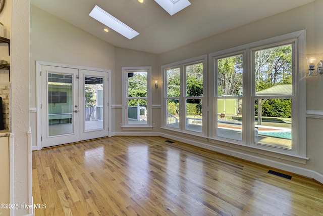 unfurnished sunroom with french doors and lofted ceiling with skylight