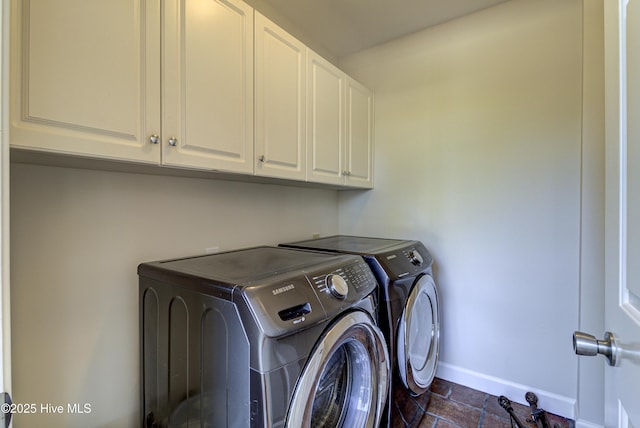 laundry area featuring washer and dryer and cabinets