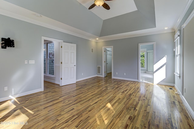 unfurnished room featuring ceiling fan, ornamental molding, hardwood / wood-style floors, and a tray ceiling