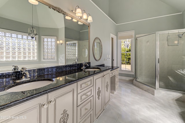 bathroom featuring lofted ceiling, vanity, tile patterned flooring, a shower with door, and a chandelier