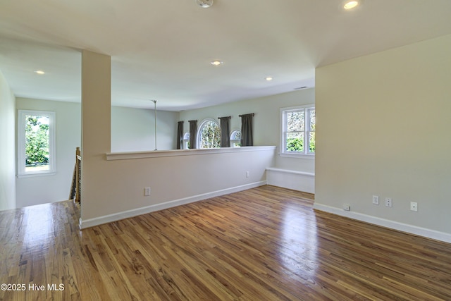 spare room featuring hardwood / wood-style floors and a healthy amount of sunlight