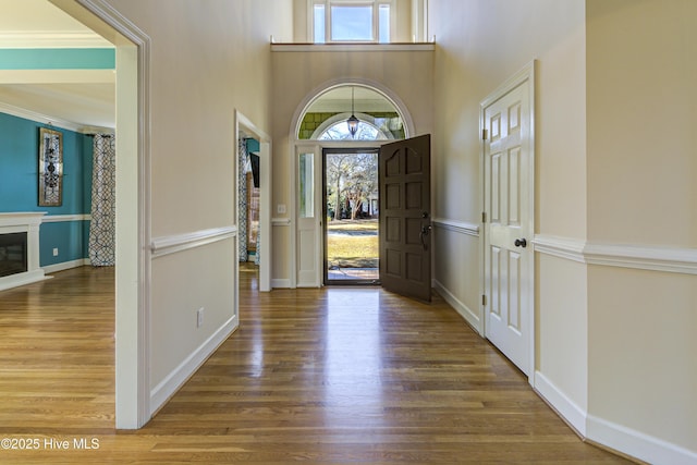 foyer entrance featuring hardwood / wood-style flooring and ornamental molding