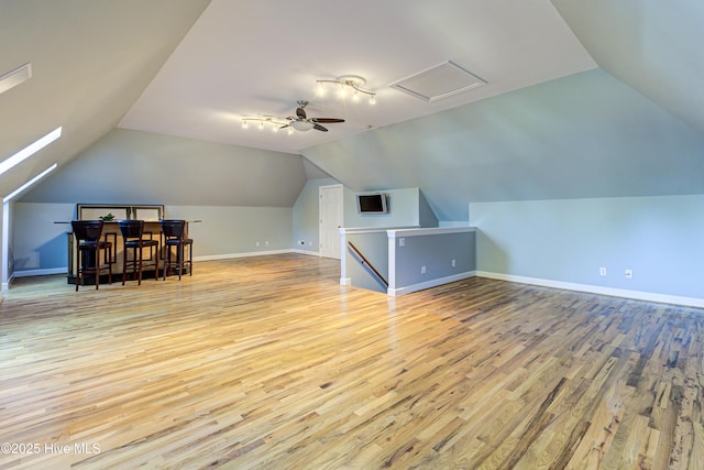 additional living space featuring ceiling fan, lofted ceiling, and light hardwood / wood-style floors