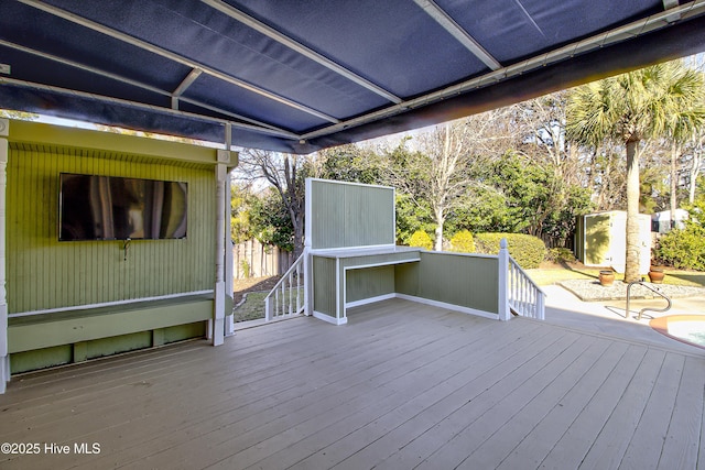 wooden terrace with a patio area