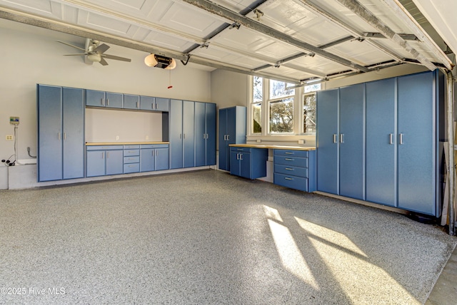 garage featuring ceiling fan and a garage door opener