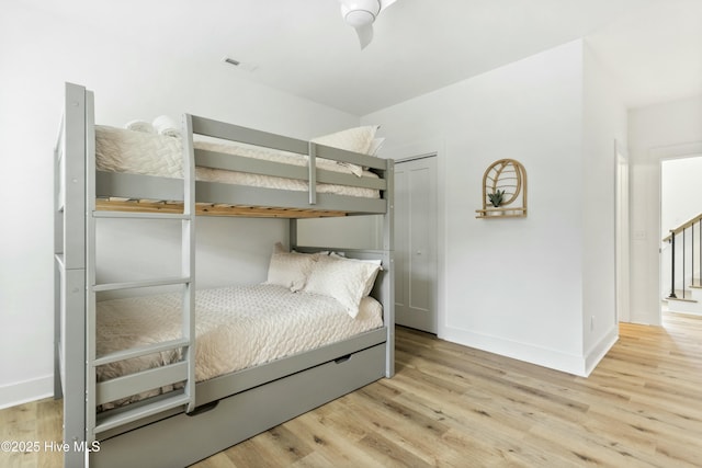 unfurnished bedroom featuring light hardwood / wood-style floors and a closet