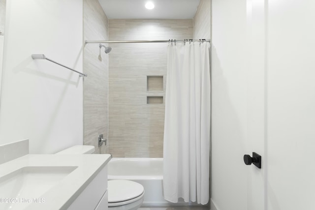 full bathroom featuring vanity, shower / tub combo, and toilet