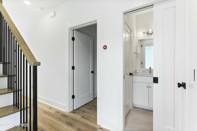 hall featuring sink and light hardwood / wood-style floors