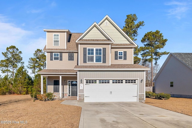 craftsman inspired home with a garage and covered porch