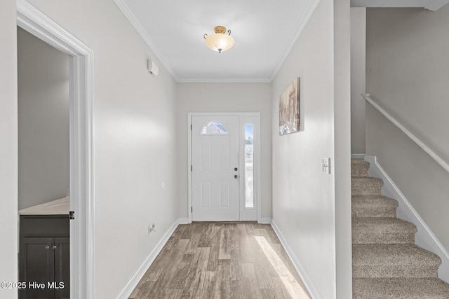 foyer entrance featuring crown molding and hardwood / wood-style floors