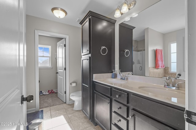 bathroom with vanity, toilet, walk in shower, and tile patterned flooring