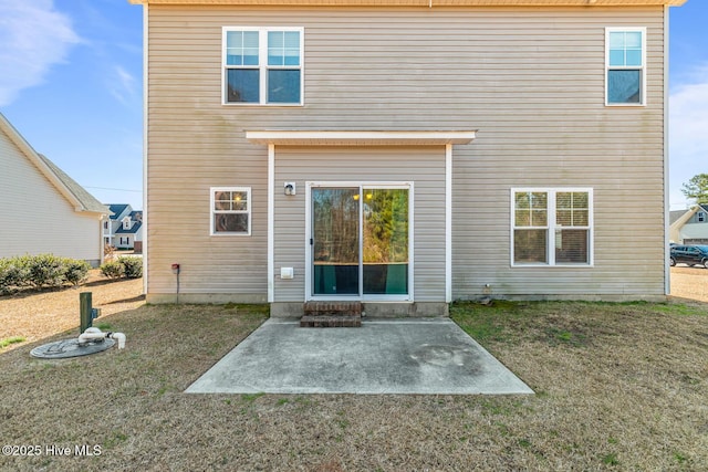 back of house featuring a patio area and a yard