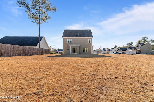 back of property featuring a yard