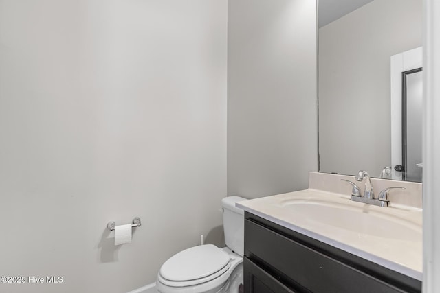 bathroom featuring toilet and vanity