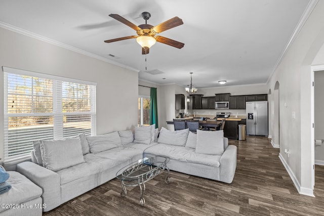 living room with crown molding, ceiling fan with notable chandelier, and dark hardwood / wood-style floors