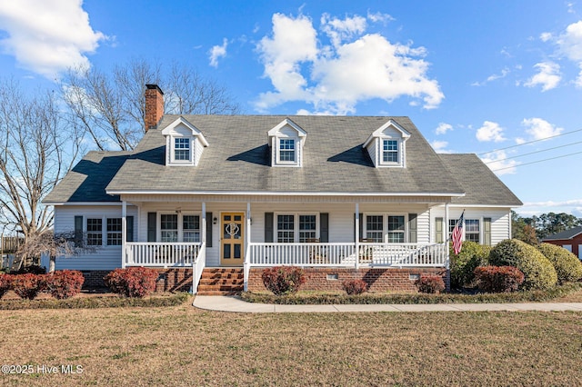 new england style home with a porch and a front yard