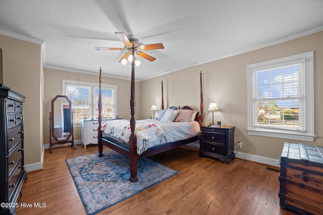 bedroom featuring ceiling fan, crown molding, and hardwood / wood-style flooring