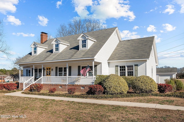 new england style home with a front yard and a porch