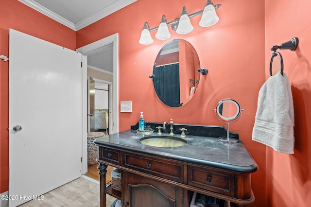 bathroom featuring vanity, ornamental molding, and hardwood / wood-style flooring