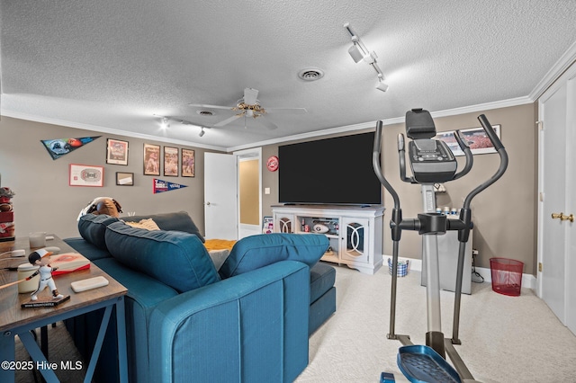 interior space featuring a textured ceiling, rail lighting, ceiling fan, and ornamental molding