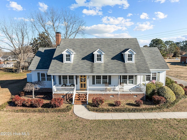 cape cod house featuring a front lawn and covered porch