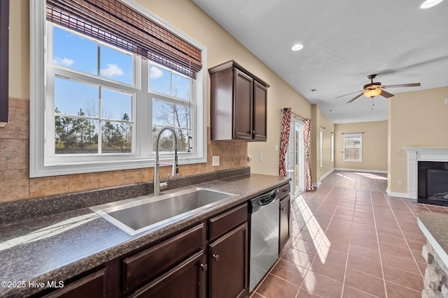 kitchen with tasteful backsplash, dishwasher, sink, dark brown cabinets, and tile patterned floors