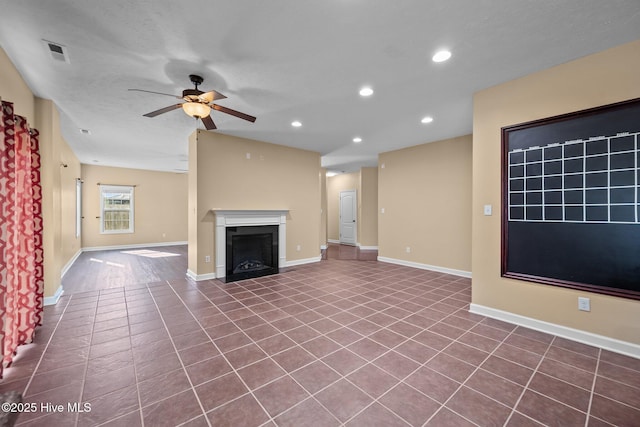 unfurnished living room featuring tile patterned floors and ceiling fan