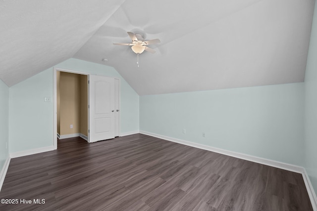 bonus room with vaulted ceiling, dark wood-type flooring, and ceiling fan