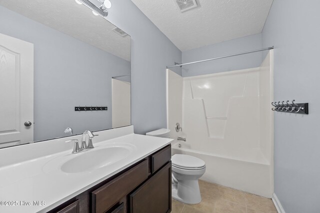 full bathroom featuring tile patterned flooring, vanity, a textured ceiling, shower / washtub combination, and toilet