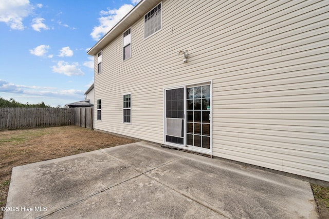 view of side of home with a patio