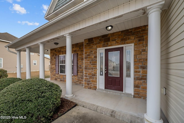 view of exterior entry with a porch