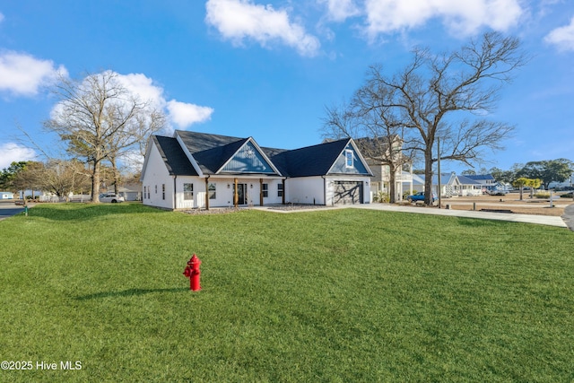 view of front of home with a garage and a front lawn